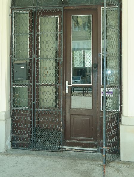 Wąskie drzwi z otwartą kratą i progiem